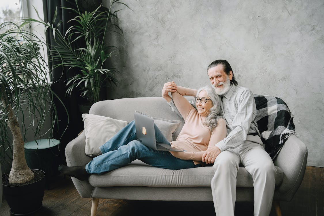 Two joyful elderly individuals smiling