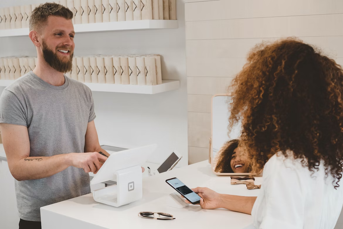 A woman placing an order at a cashier's counter