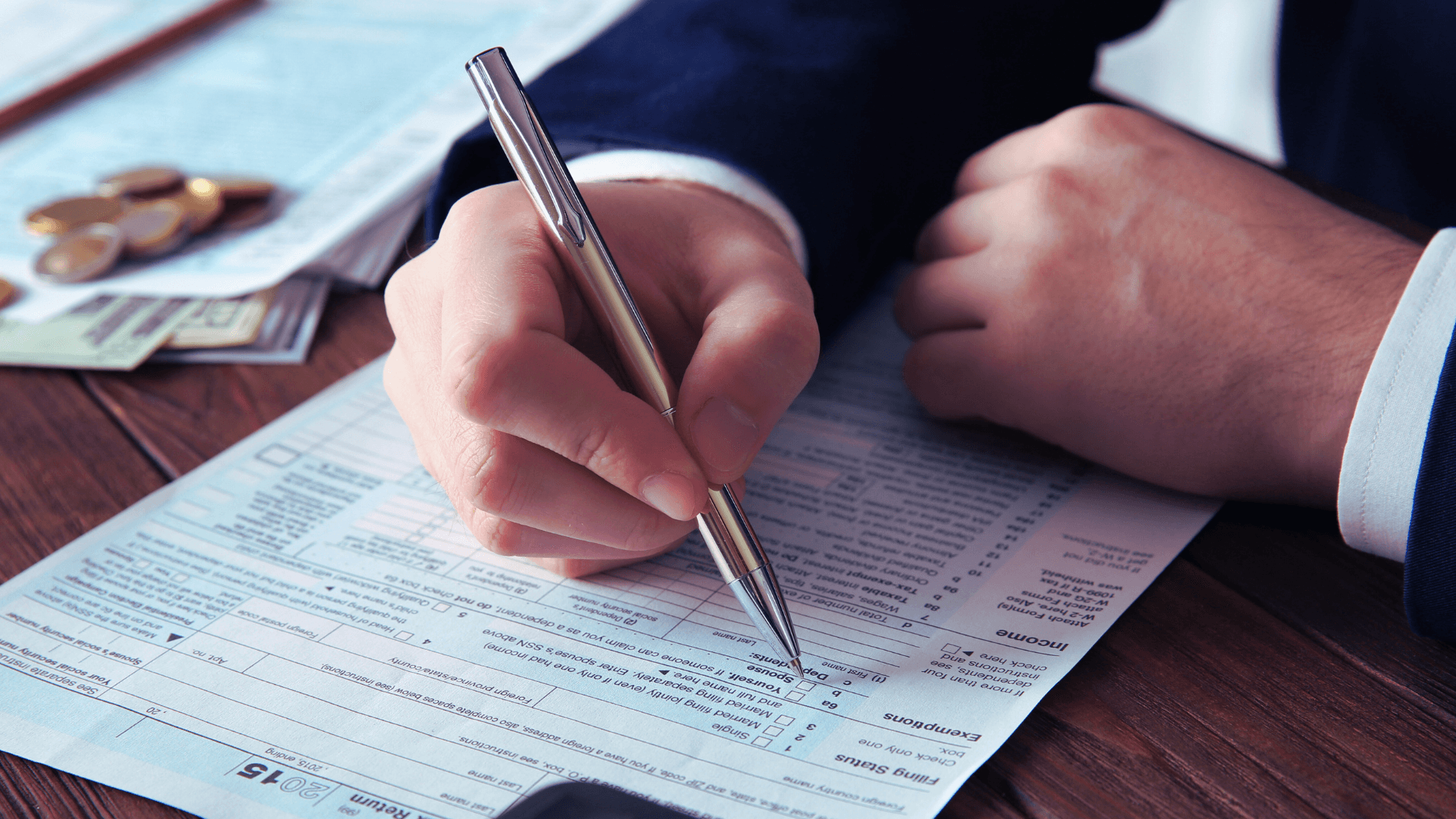 A man in suit filling out his W-2c form 